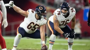 This image is about Chicago Bears offensive linemen preparing for the snap during an NFL game.