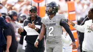 This image is about Deion Sanders and he is giving instructions to his teammates
