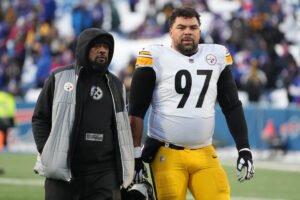 This image is about Cameron Heyward and Mike Tomlin walk off the field.