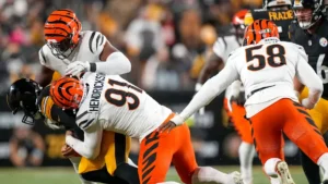 This image is about Trey Hendrickson (#91) of the Bengals making a tackle during a game against the Steelers.