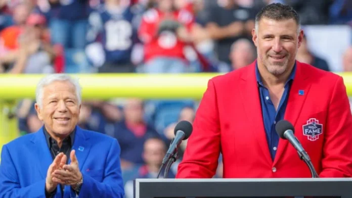 This image is about Hall of Fame event with a speaker in red and a supporter clapping.