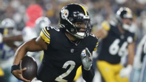 This image is about Pittsburgh Steelers quarterback, running with the football .