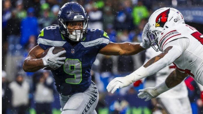 This image captures a thrilling football moment between the Seattle Seahawks and the Arizona Cardinals