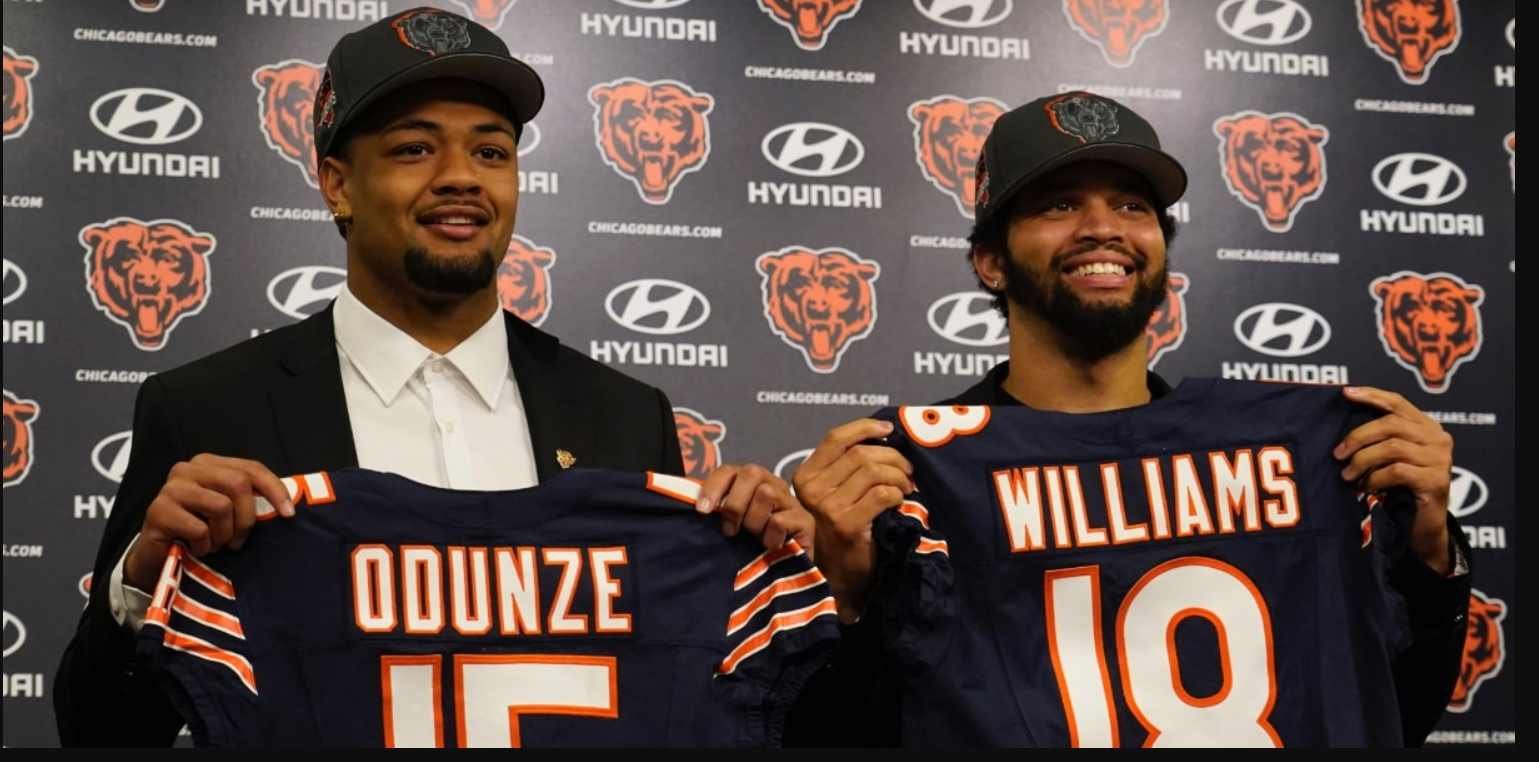 This image features two individuals holding up Chicago Bears football jerseys with the names "Odunze" and "Williams" on them